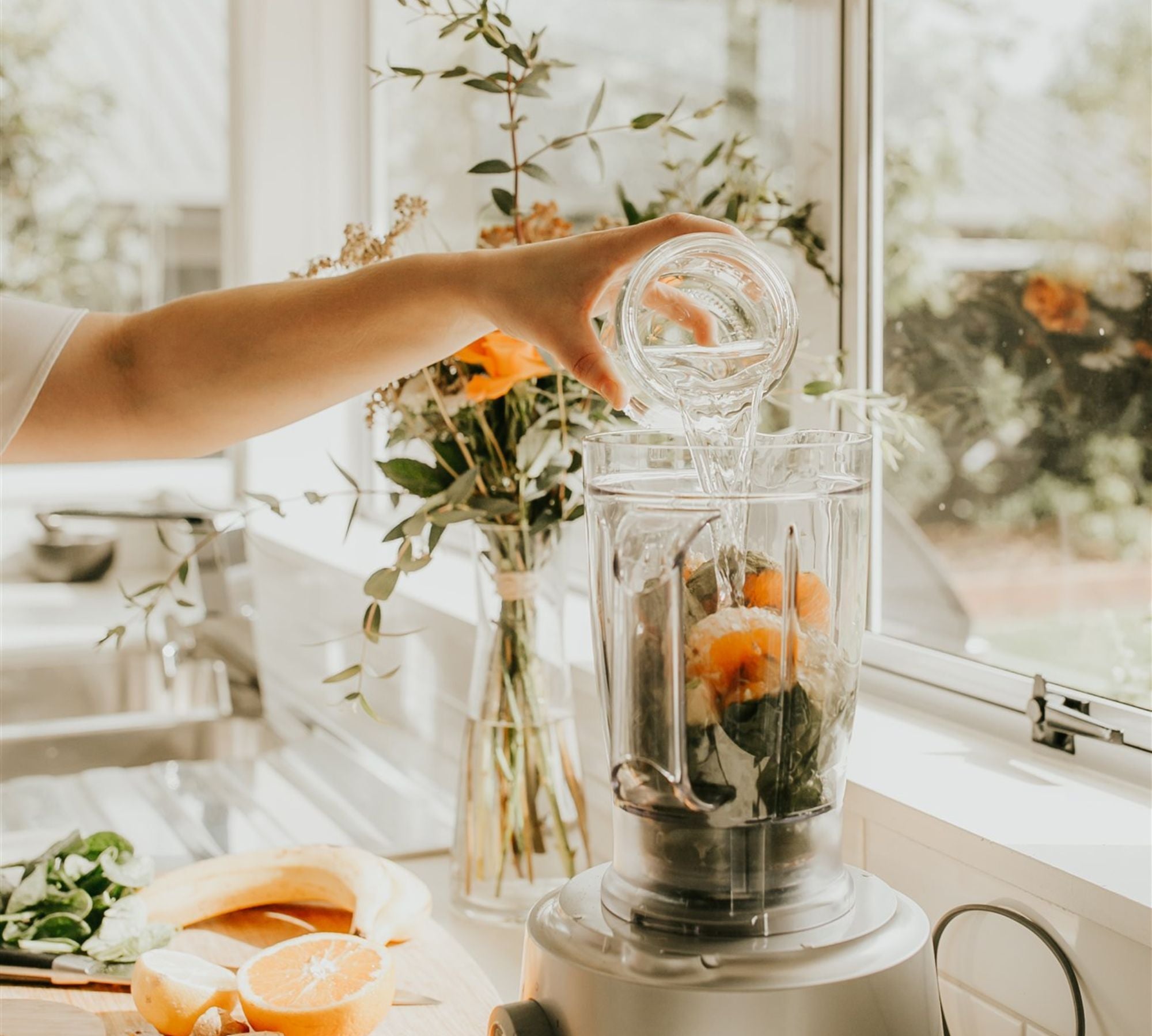 Smoothie being prepared with Oranges and Spinach
