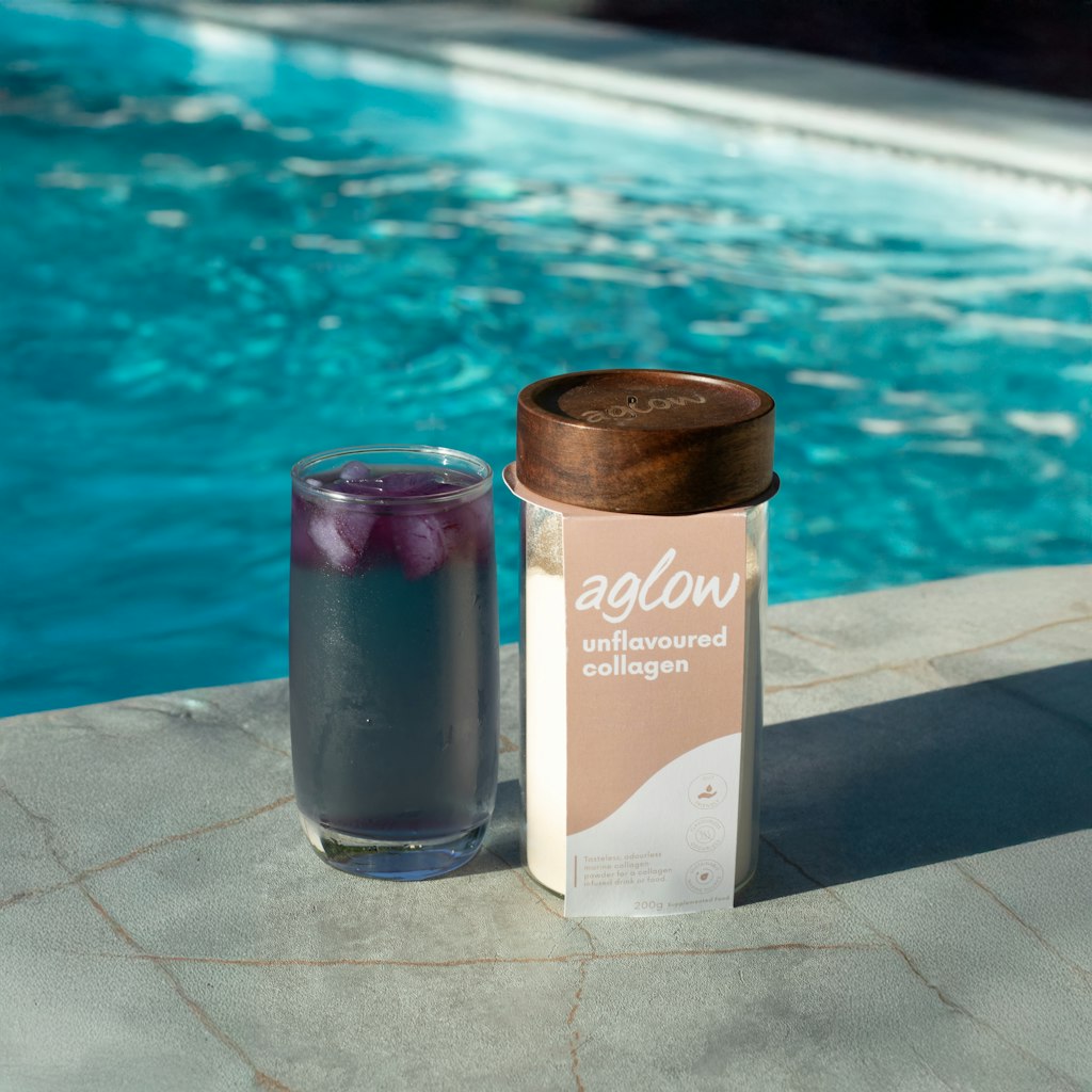 Aglow marine collagen with drink beside pool