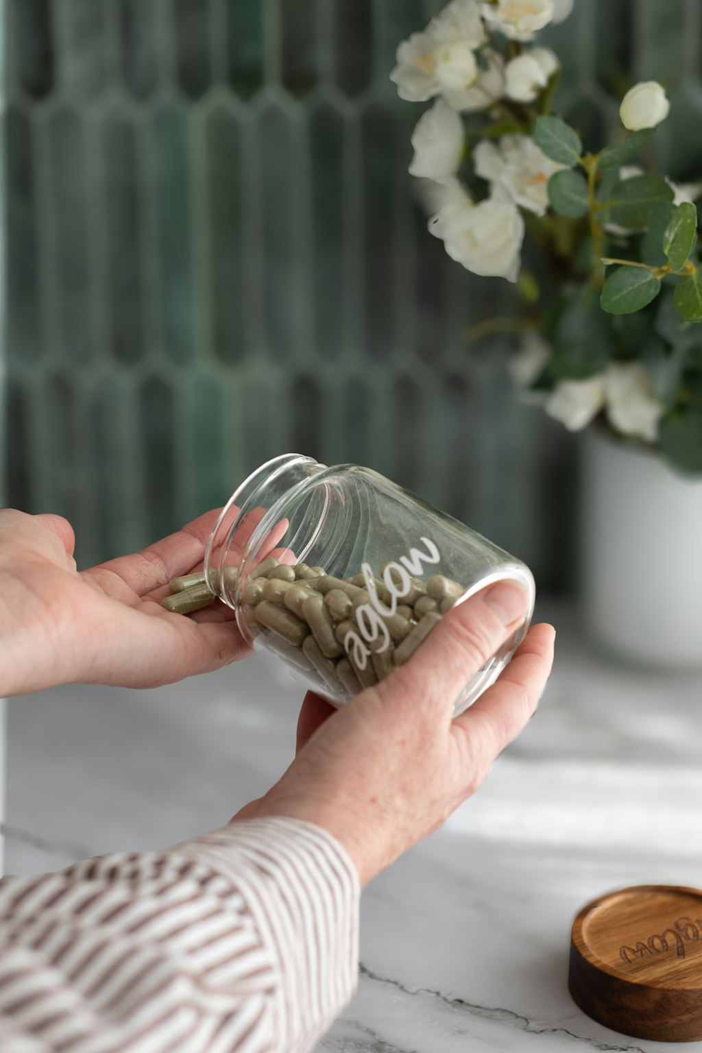 Pouring super greens capsules into a hand