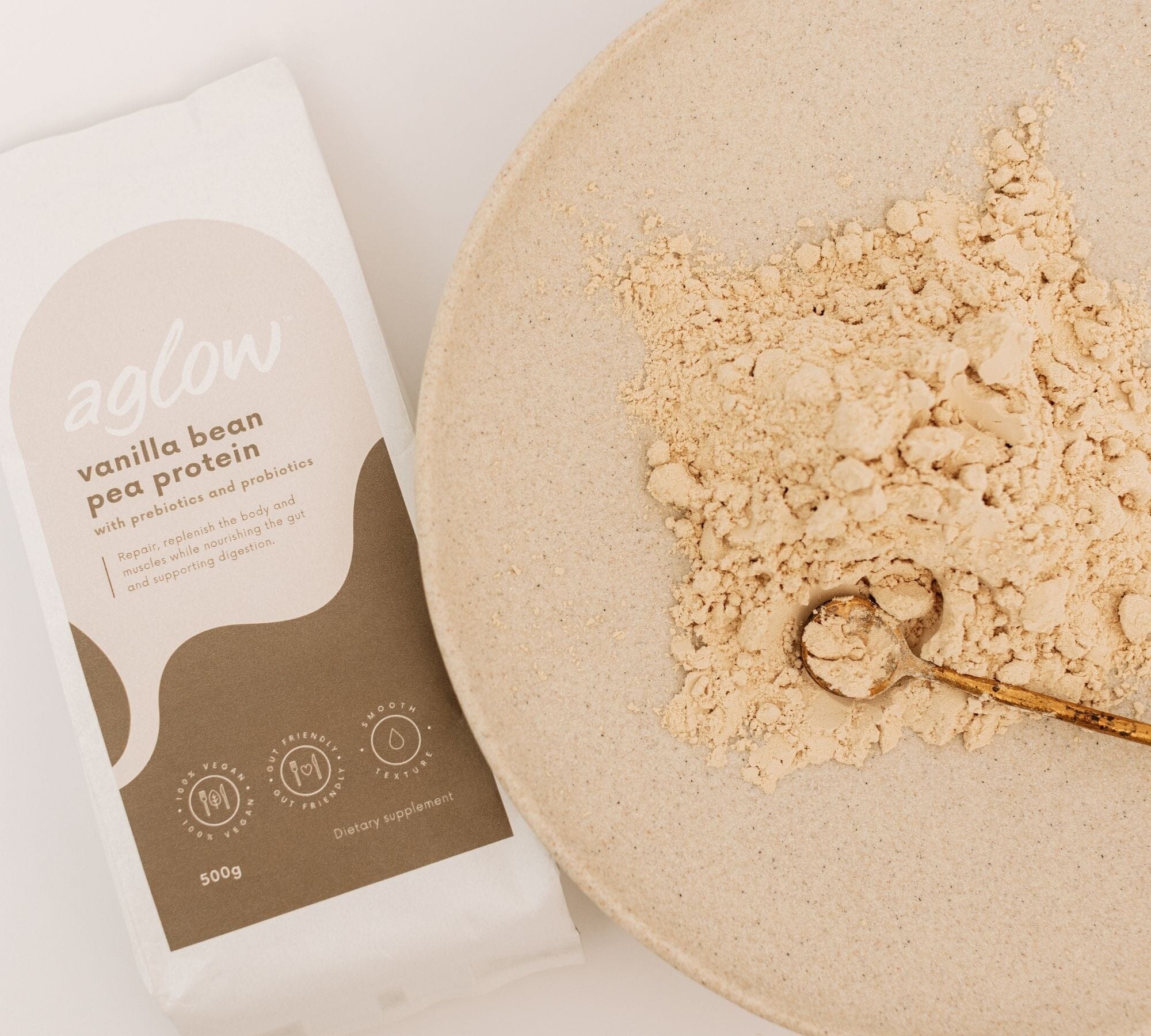 Vanilla Bean Pea Protein with Prebiotic + Probiotics with powder poured on a plate